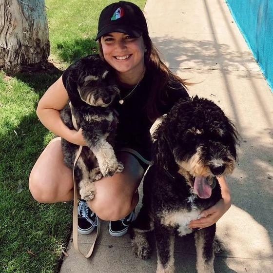 Emma Barr, founder of Bella Paws Co., out with two dogs